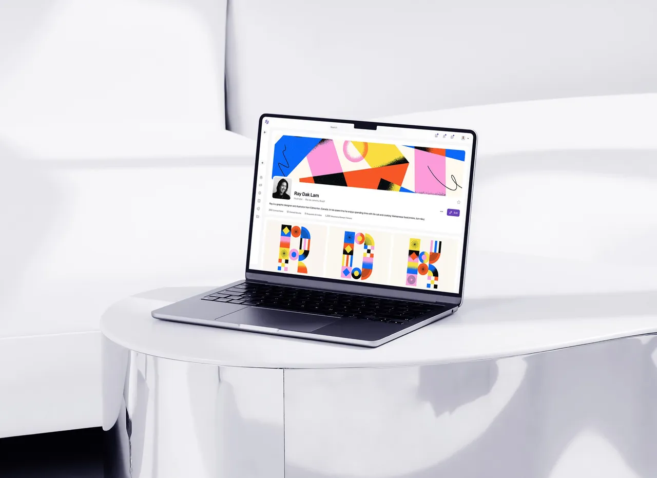 Laptop on a round table showing a Noum page with colourful artwork